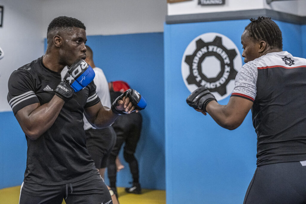 Two MMA fighters sparring at London Fight Factory, focusing on guard positioning.