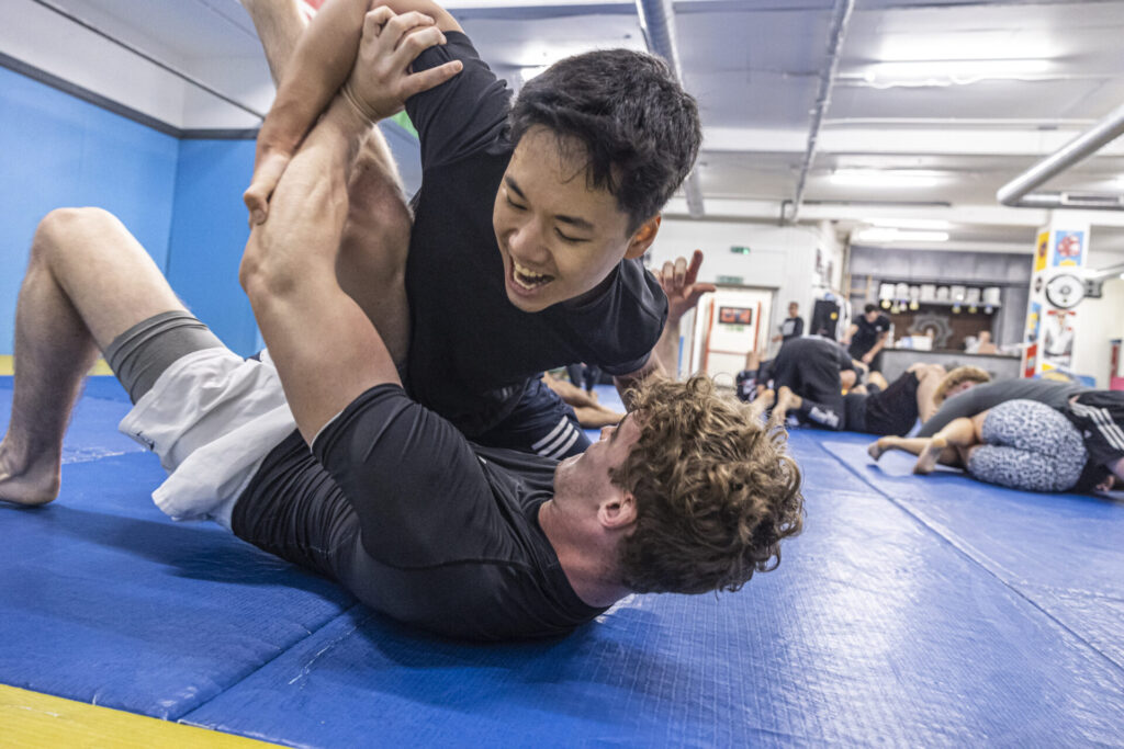 Two fighters practicing a ground technique in Brazilian Jiu-Jitsu at London Fight Factory.