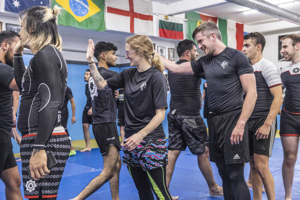 High-five between fighters after a Brazilian Jiu-Jitsu training session at London Fight Factory.