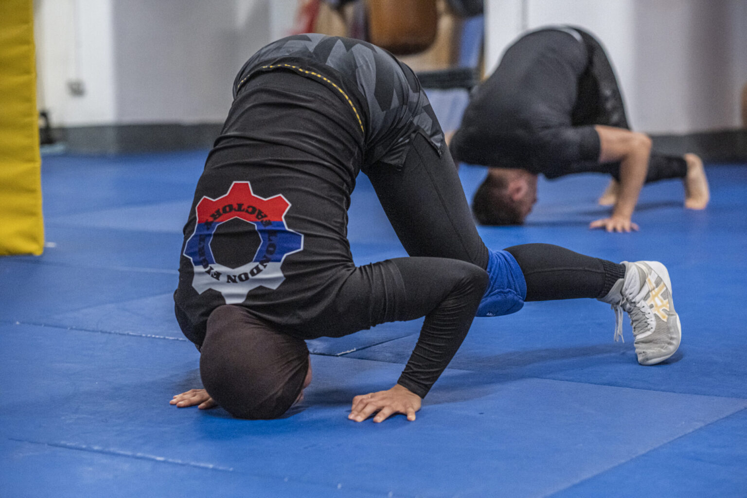 Martial artist practicing flexibility drills at London Fight Factory.