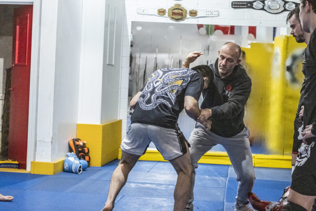 Coach demonstrating SAMBO technique with a student at London Fight Factory.