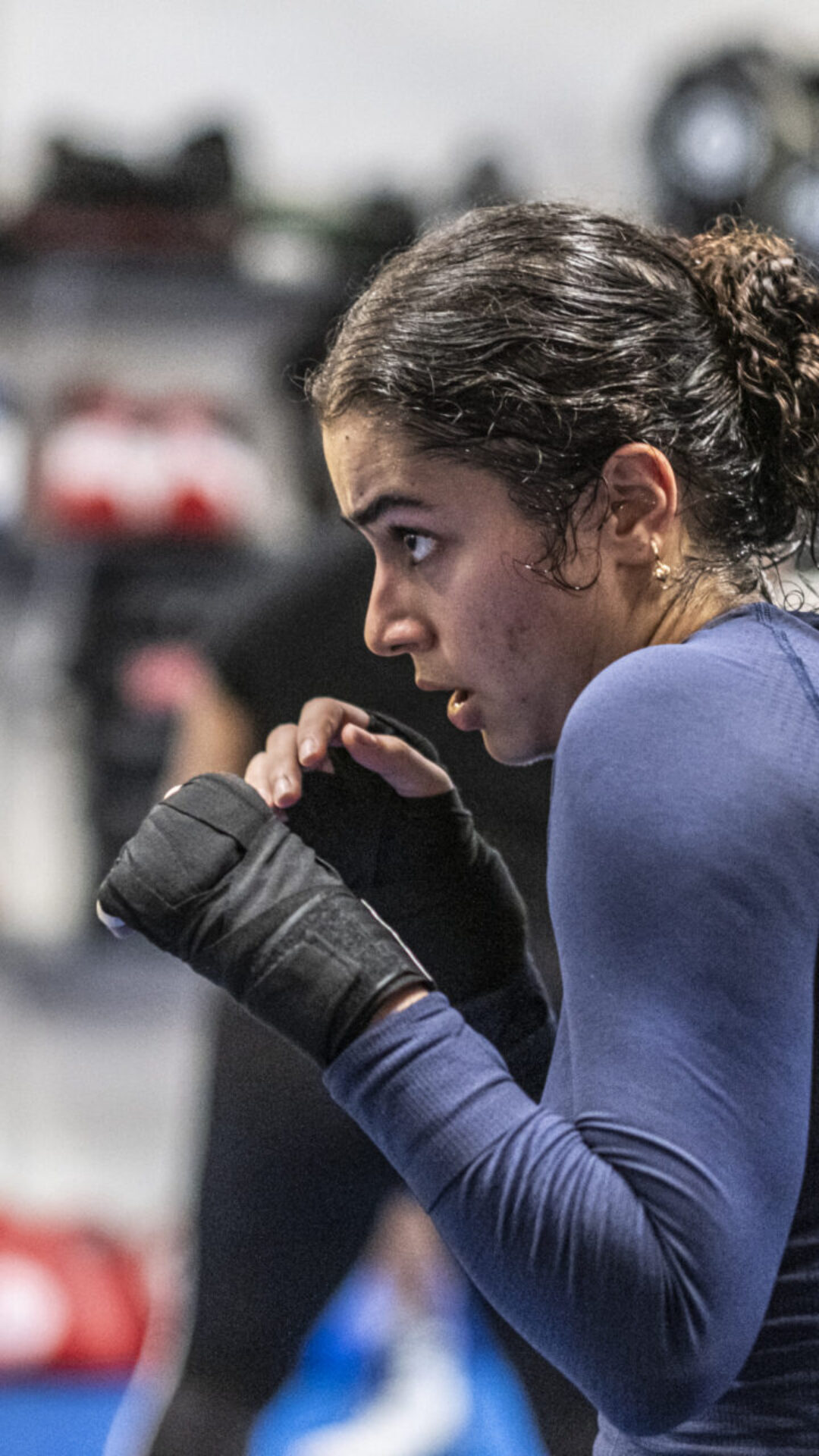 Female boxer practicing punching form at London Fight Factory.